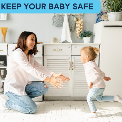 Toddler running toward smiling mom in kitchen with magnetic cabinet locks visible on white cabinet doors