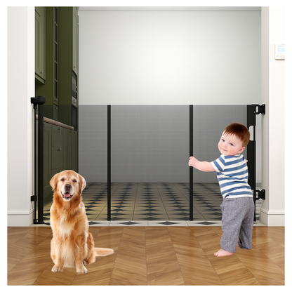 Toddler and golden retriever separated by black retractable mesh baby gate spanning wide hallway doorway