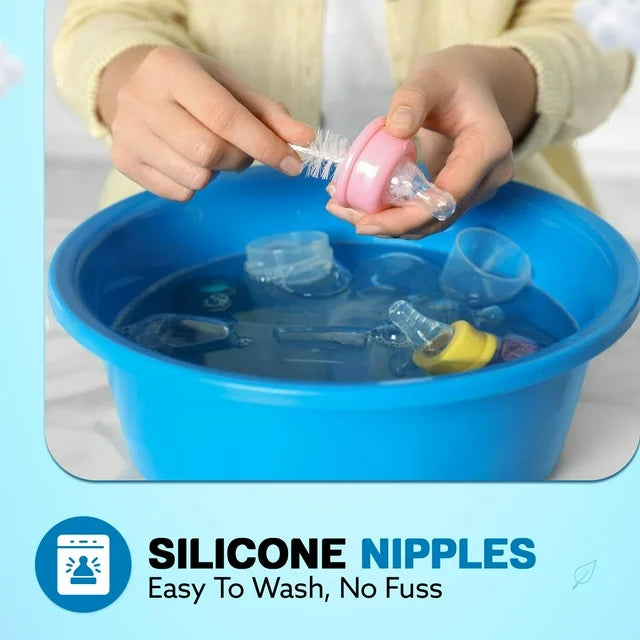 Parent scrubbing pink SkinSoft Silicone Nipple with bottle brush over blue basin of soaking nipples