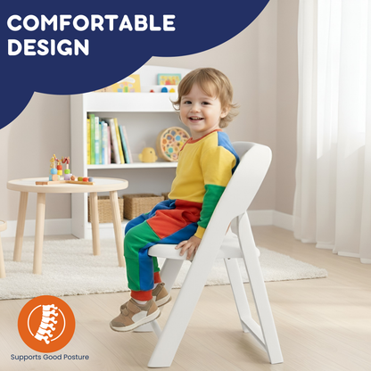 Smiling toddler sitting upright in white kids folding chair in a bright playroom, posture-supporting backrest visible