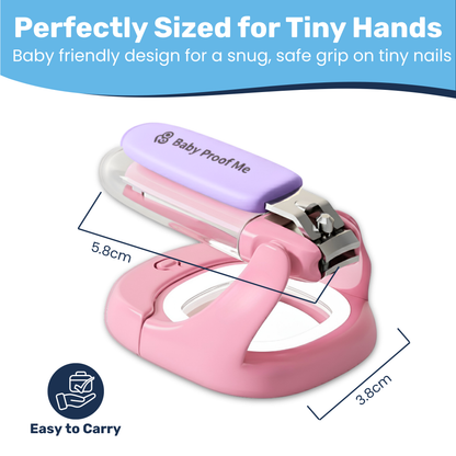 Pink baby nail clipper with 5.8cm x 3.8cm dimensions labeled, purple LED magnifier cap and finger-loop base