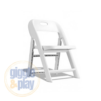 White kids folding chair in open position, fold-flat PP plastic build with carry handle cutout in backrest